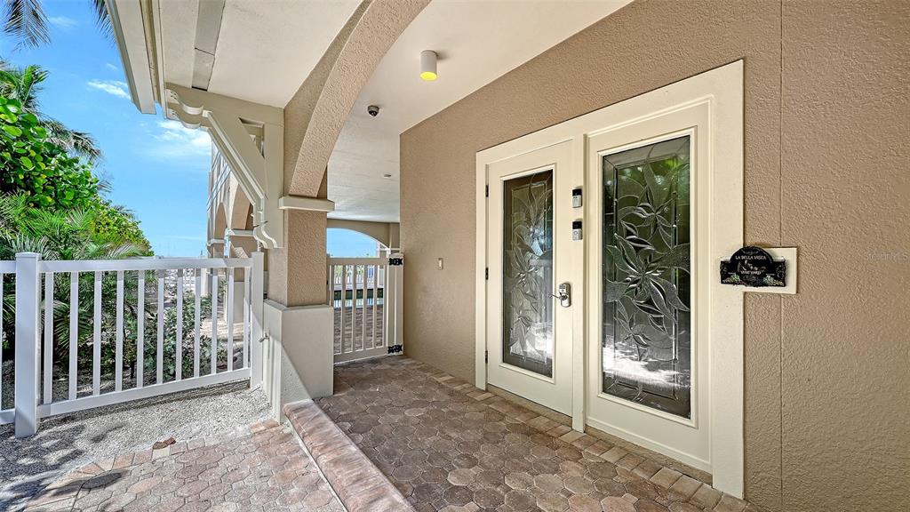 Front door entrance to building. Note: 2 low steps into building foyer could accommodate wheelchair access to elevator. Garage also has 1 low step into the foyer.