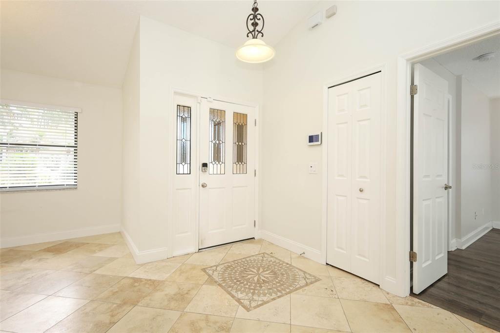 Foyer with Travertine tile flooring.
