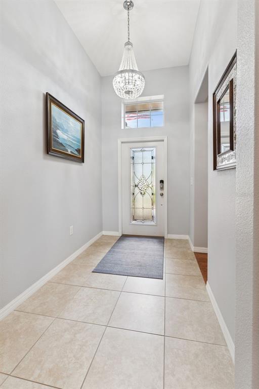 Custom Leaded Glass Front Door, Transom Window and Chandelier enhance the foyer