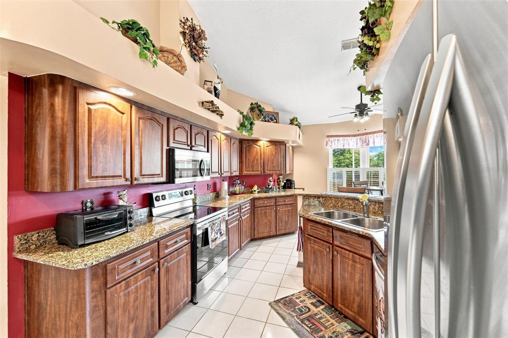 Gorgeous kitchen with granite countertops, stainless steel appliances purchased in 2023, and tons of cabinetry space!