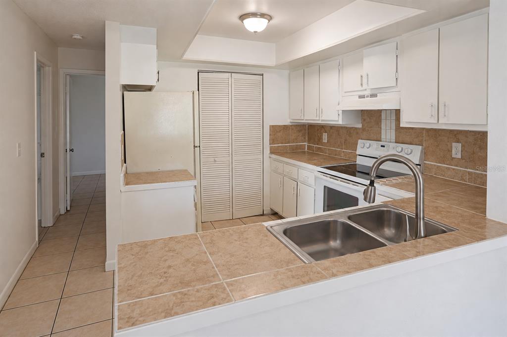 Kitchen with pantry and opening from dining area.  Bedrooms at left.