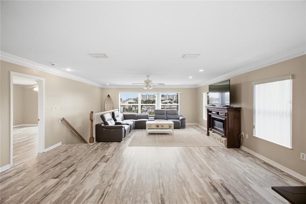 Living Room with natural light and gorgeous crown molding!