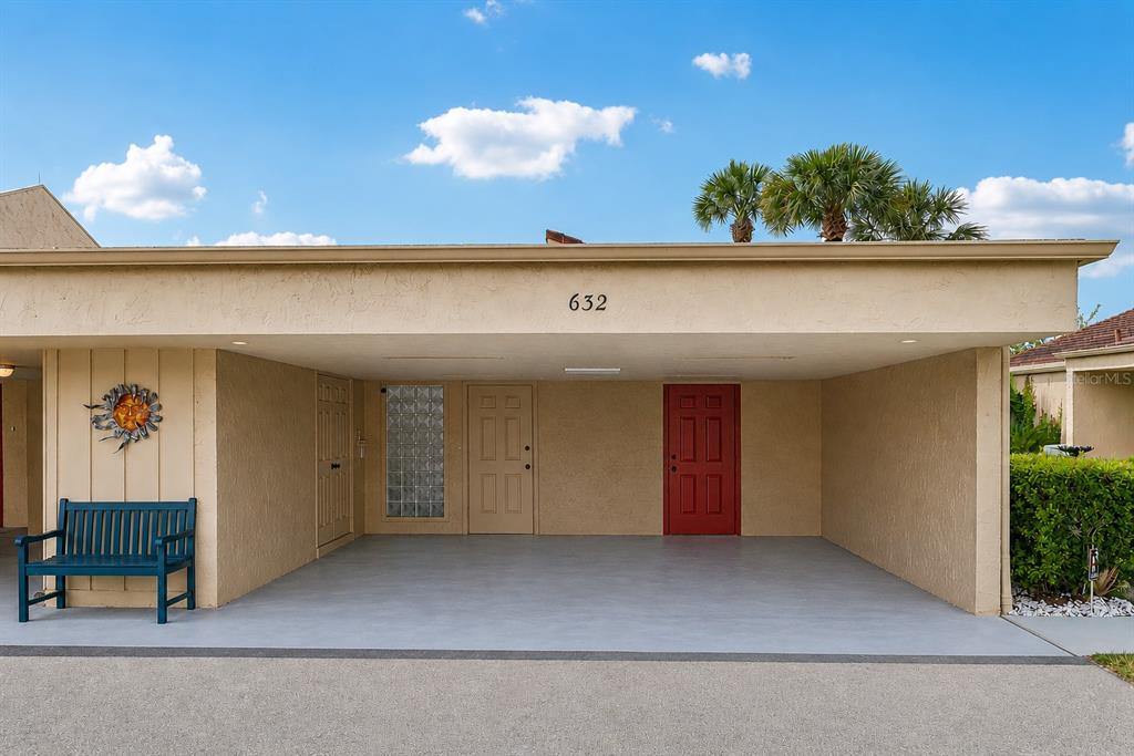 Two-car carport with additional storage and a private front entrance.