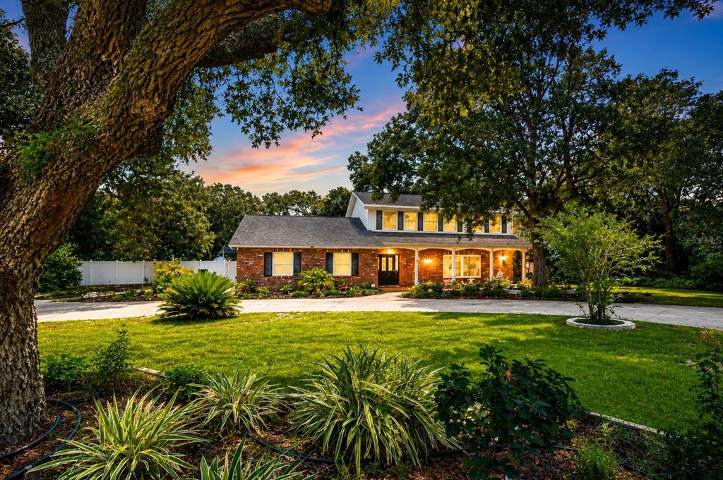 Refreshed landscaping, mature trees, and drip irrigation create a beautiful park-like setting