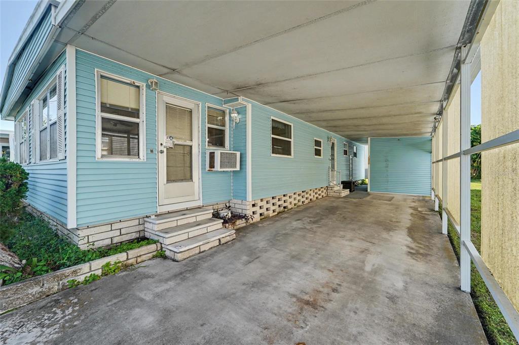 Large Carport and storage shed straight ahead