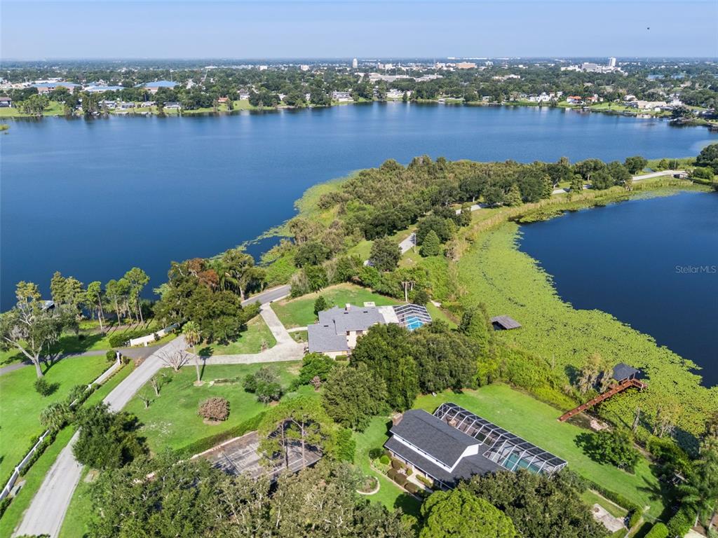 Aerial view showcasing the beautiful chain of lakes surrounding the area, highlighting the home’s exceptional lakefront setting and the natural beauty of its surroundings.