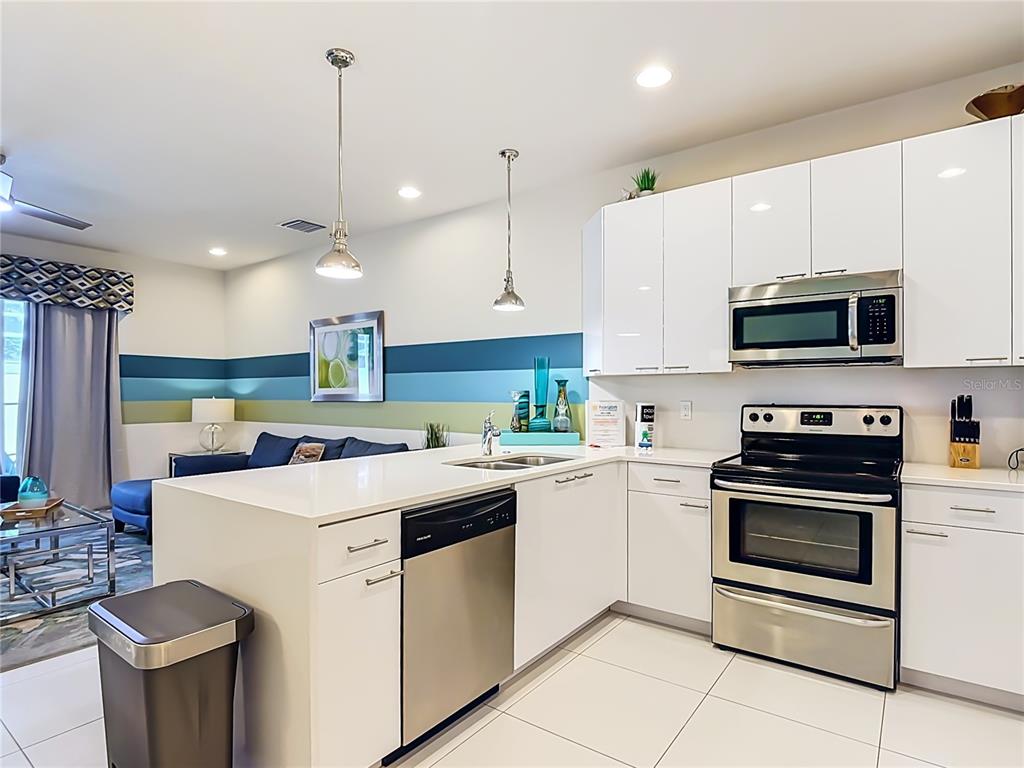 Modern kitchen with granite countertops & stainless steel appliances