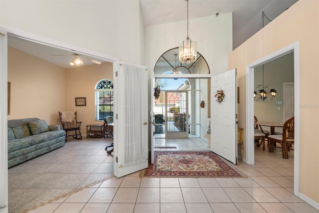 Illustrating double front doors with a screened in entry.