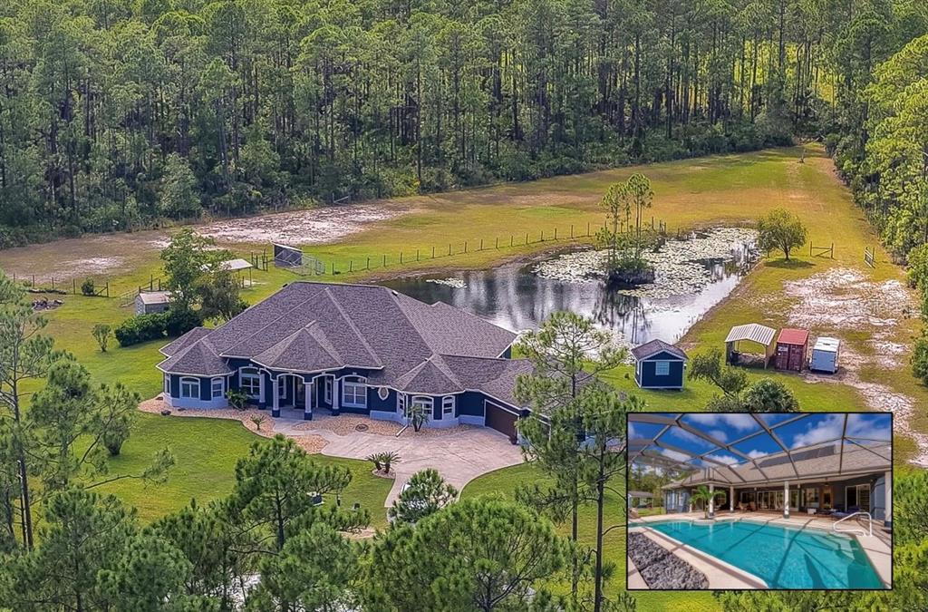 Expansive private home surrounded by dense green forest, a scenic pond, and a long paved driveway.