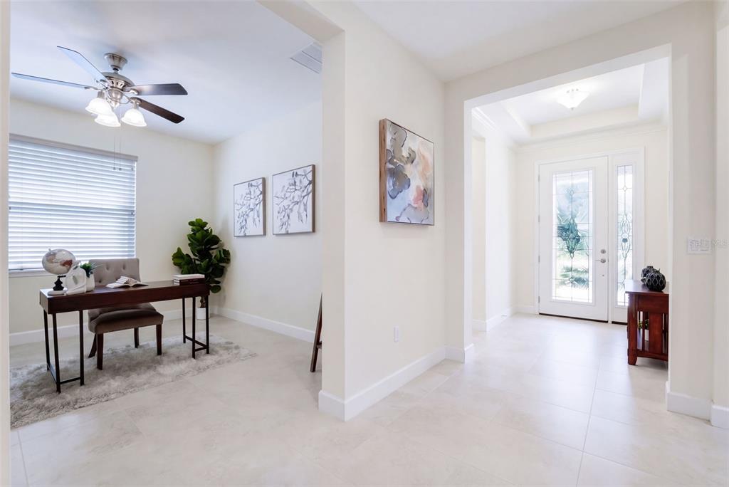 Foyer entryway w/ leaded glass door, sliding screen door, porcelain tile & a tray ceiling