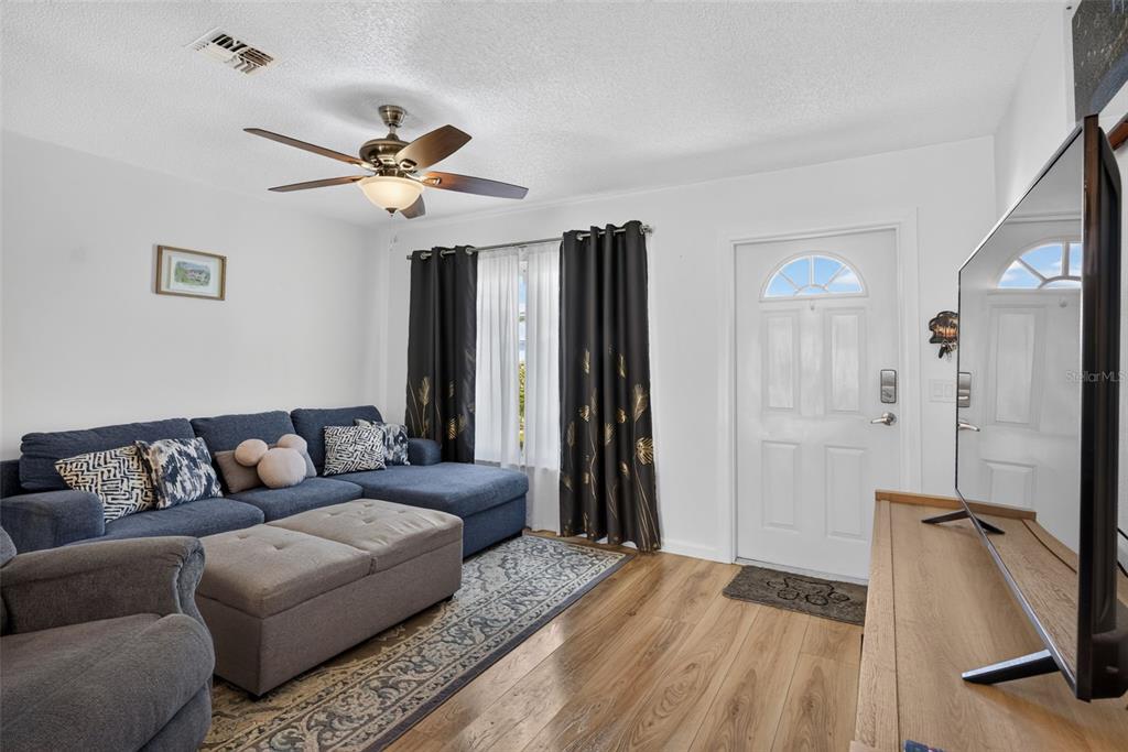 Living room showing entryway of front door