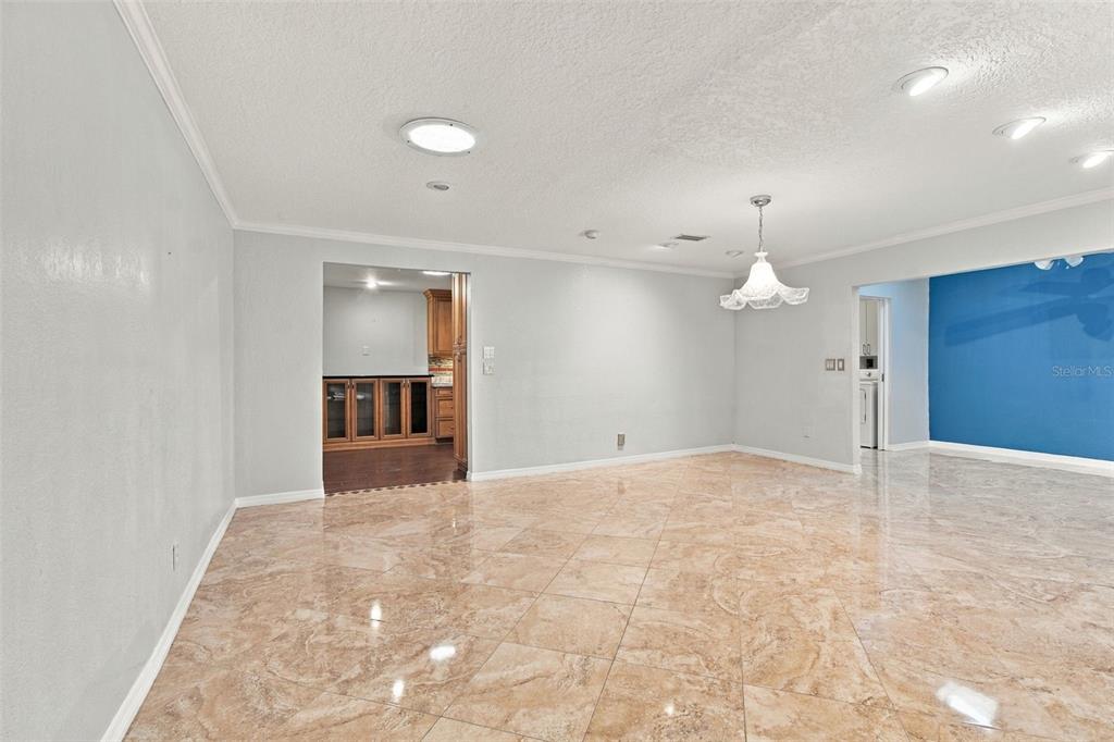 Wow! This dining room is huge and opens to the Sunroom with two skylights on the right and the kitchen on the left.