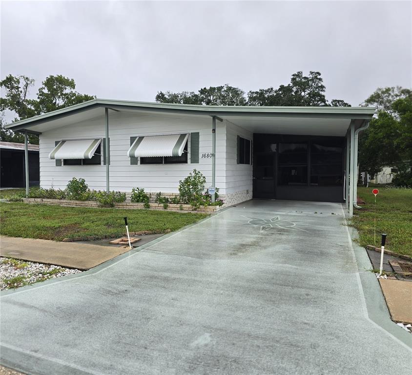 VIEW OF CARPORT & FRONT EXTERIOR