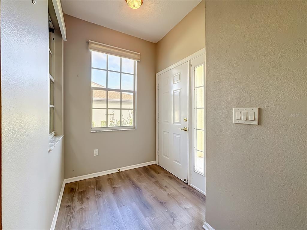Entrance and foyer with luxury vinyl plank flooring.