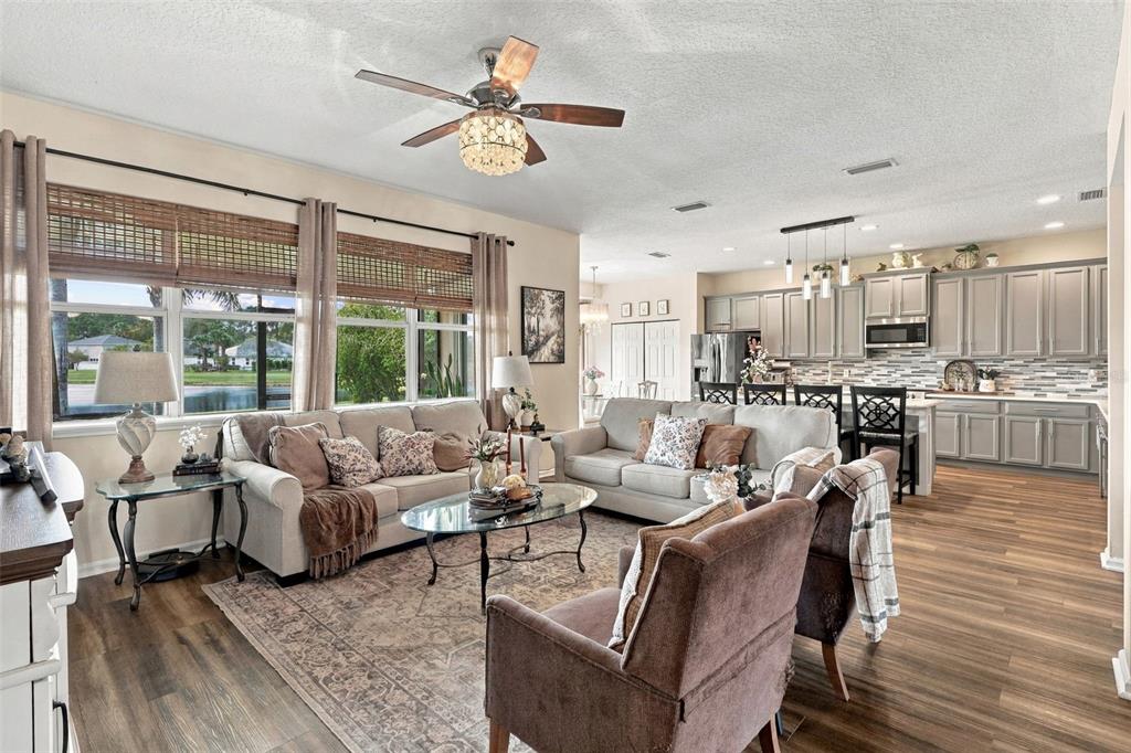 The kitchen opens to the spacious living room. Take a look at all those windows providing natural lighting throughout the home