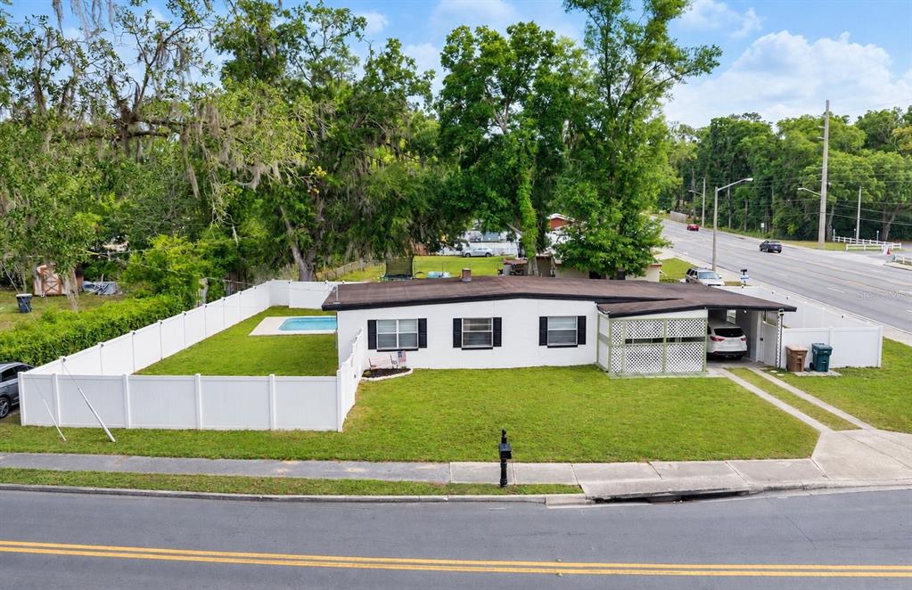 Corner lot pool home with vinyl fence