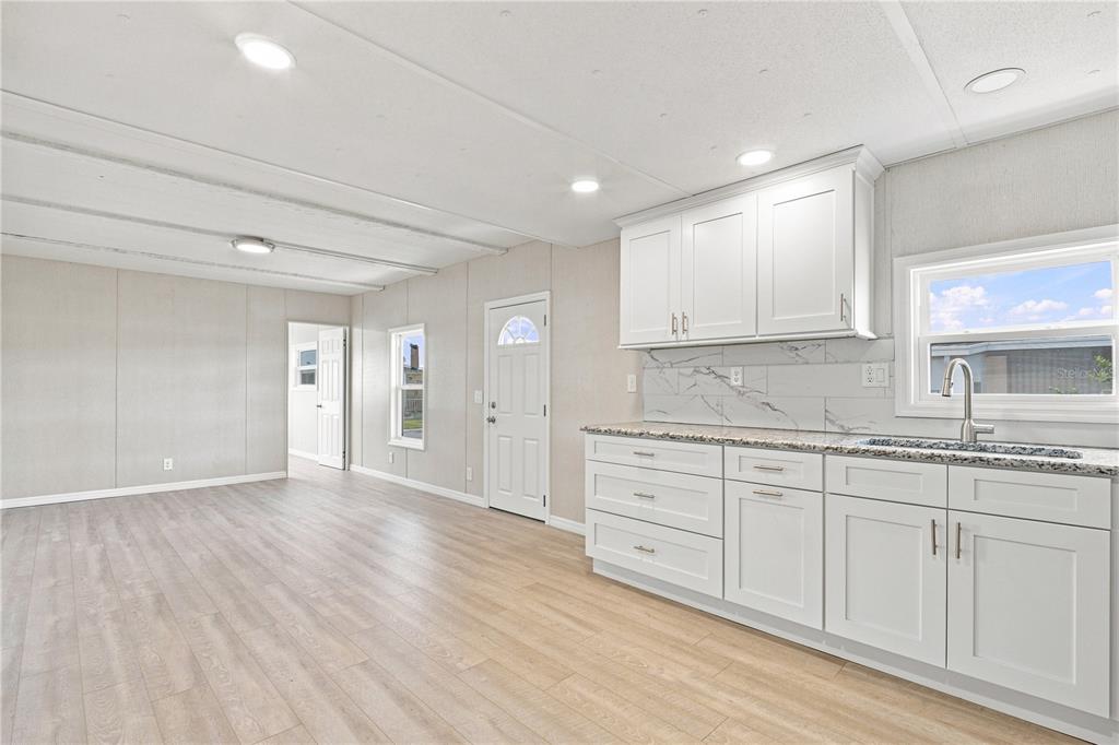 Open floorpan - Kitchen with shaker cabinets and granite counters.