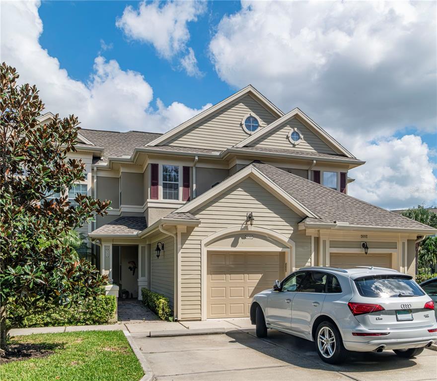 Front Elevation. One car garage and two parking spaces out front. Entrance on the left side, OR by elevator in the garage. Unit is the entire second story and an end unit for additional windows and light
