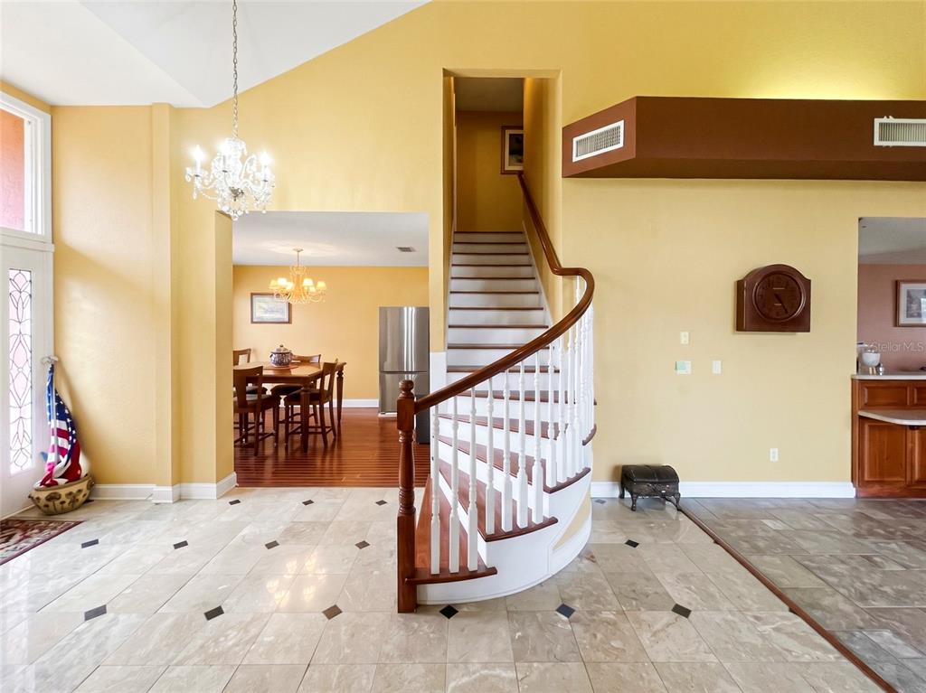 CUSTOM STAIRWELL. MARBLE FOYER.