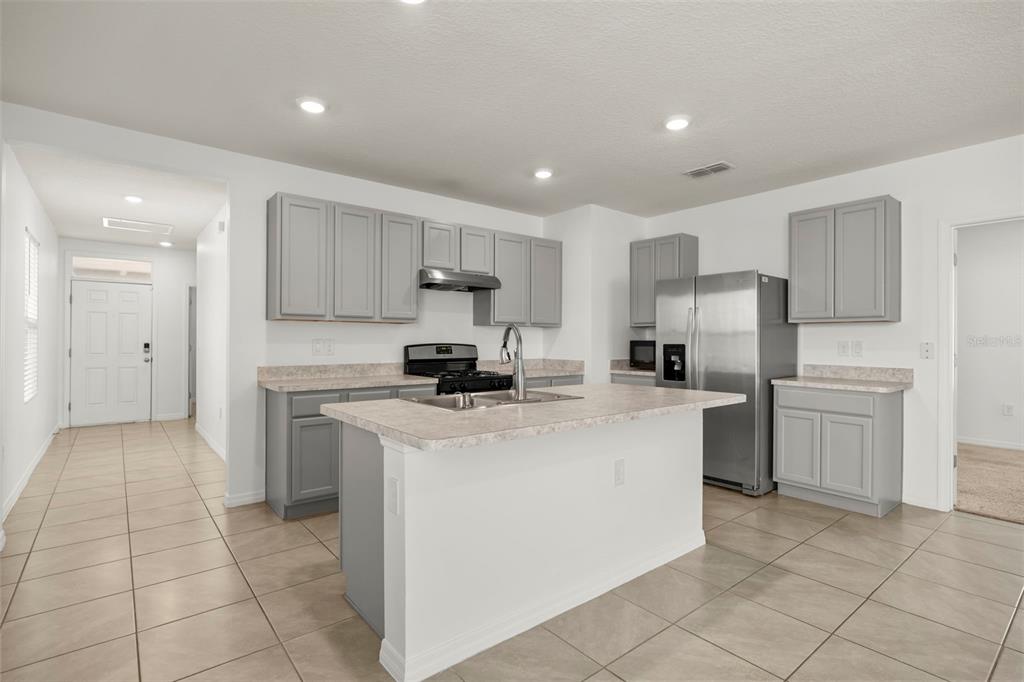 Large center island provides additional prep space and a natural gathering point.