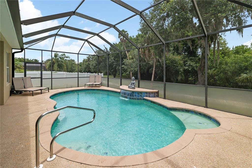 Tranquil oversized pool and undercover area for enjoying the year round Florida sunshine, rubberized pool deck surface for the the young ones enjoyment, heated pool
