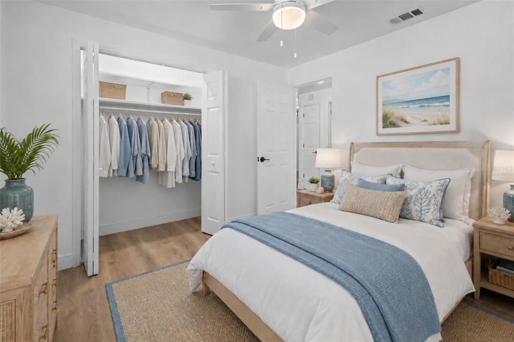 Bright and comfortable 1st bedroom featuring luxury vinyl plank flooring and a built-in closet - Virtually Staged