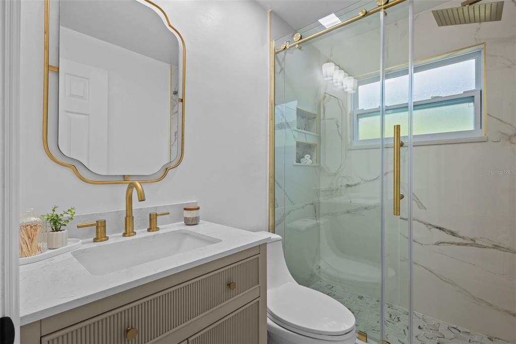 Tastefully remodeled full bathroom with updated fixtures and a clean, contemporary finish - between rooms 1 and 2
