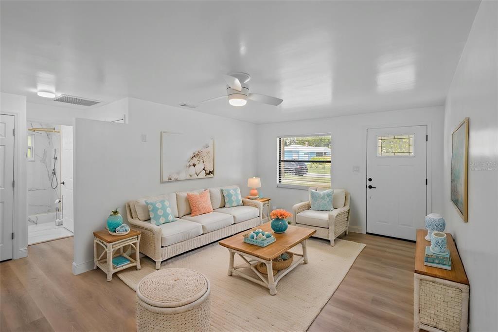 Natural light fills the main living space, creating a comfortable setting for relaxing or entertaining - Virtually Staged