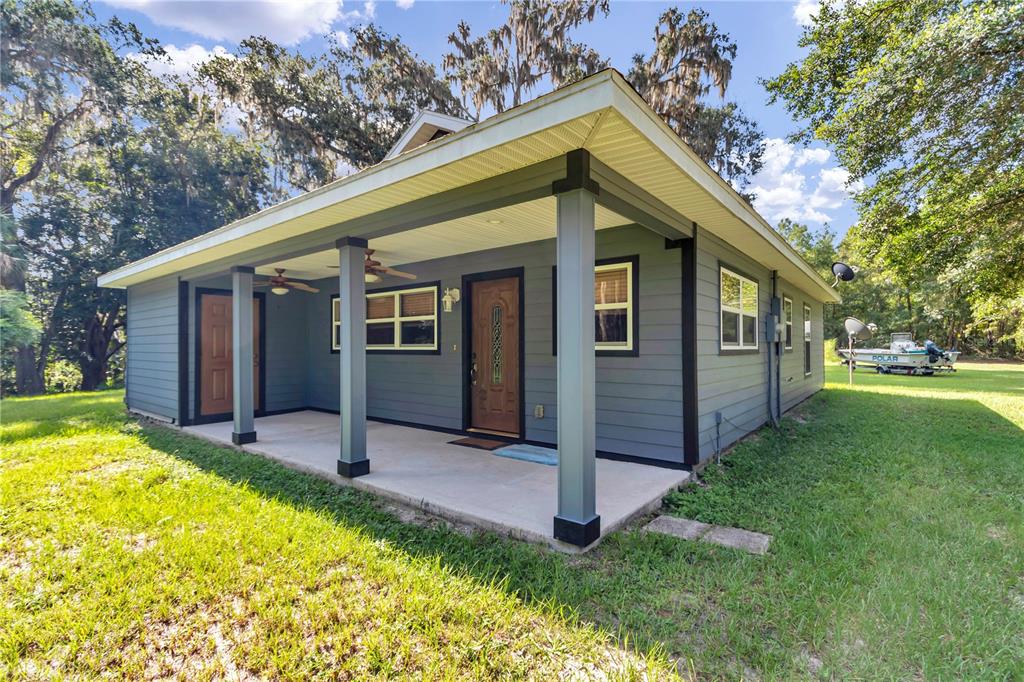 The front porch has two fans, as well as a separate entrance for the added bedroom