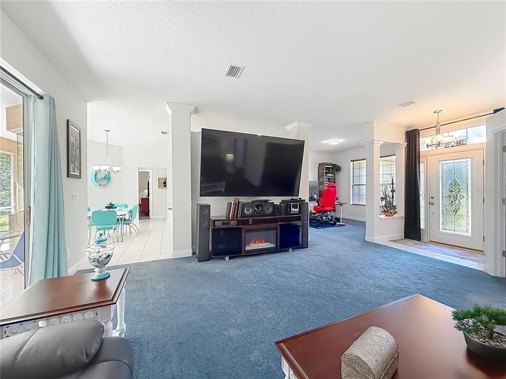 Spacious family room with plush carpet and natural light