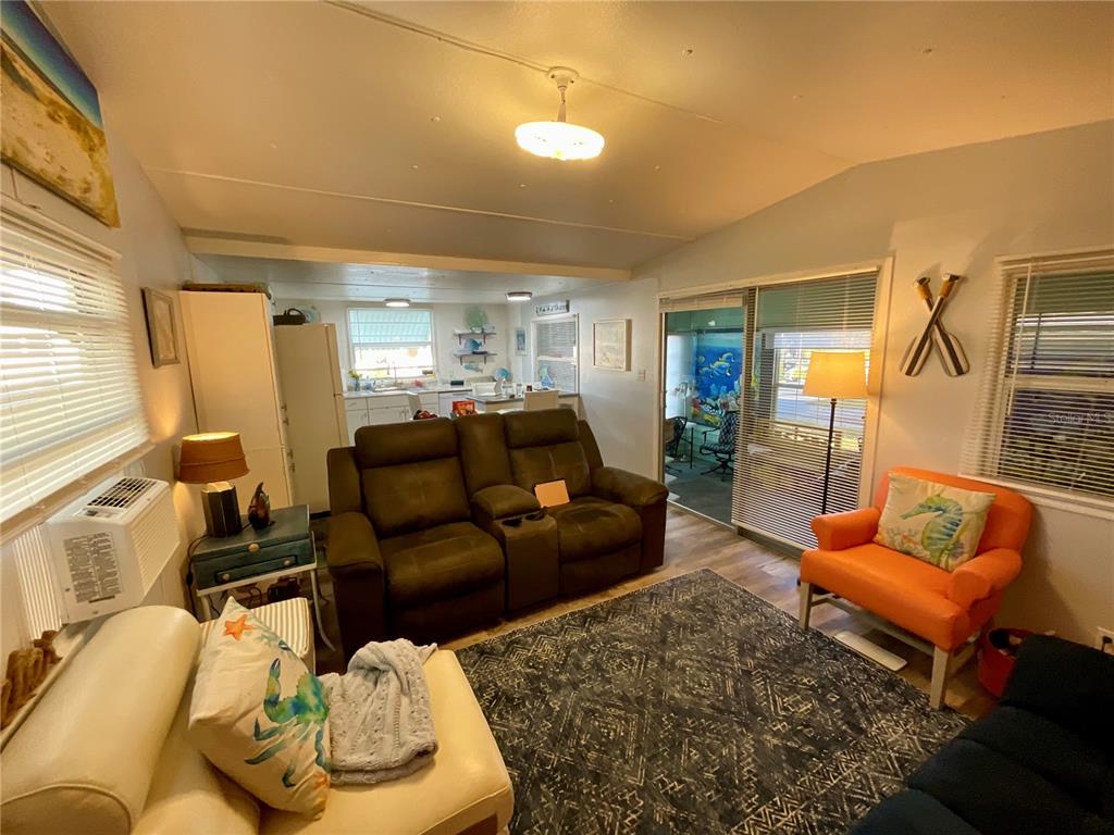 Open Living, Dining, and Kitchen floorplan. Flooded with light. Laminate flooring, neutral paint