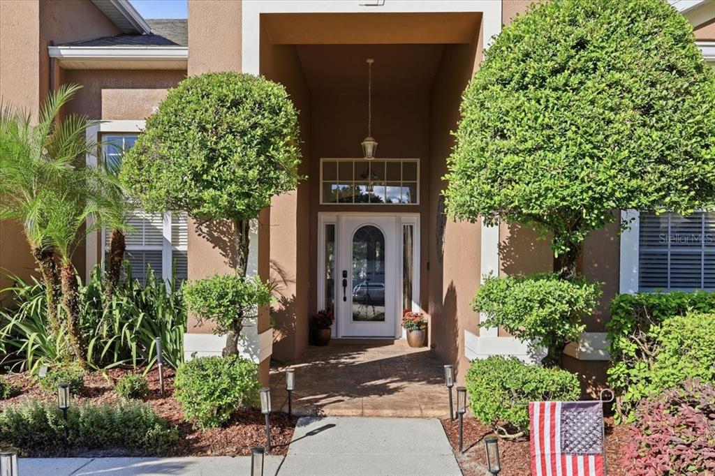 Manicured landscaping, covered front entry.