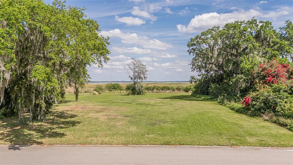 VIEW OF THE LOT FROM THE ROAD LOOKING OUT TO THE LAKE