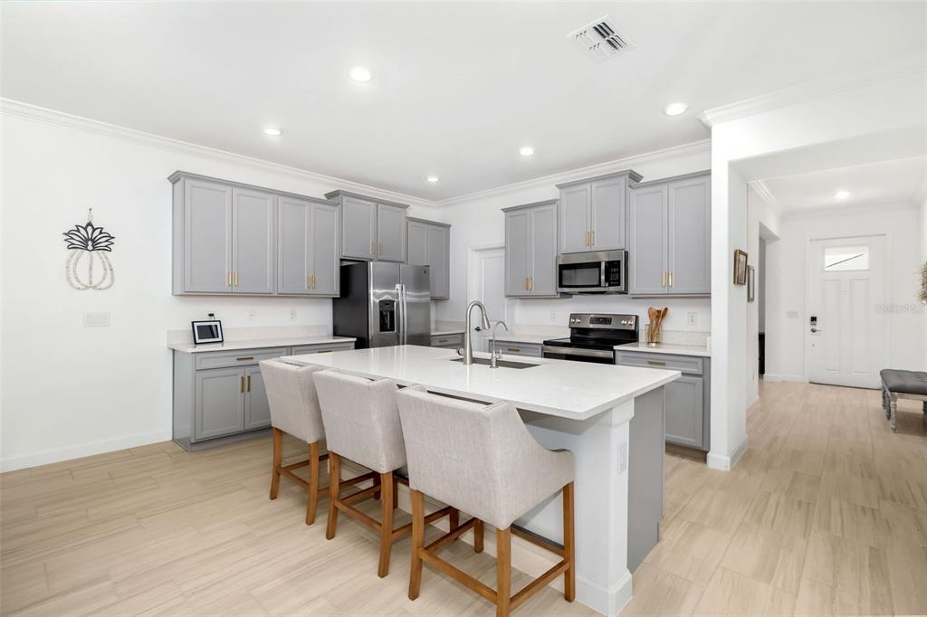 Modern kitchen with oversized island, abundant cabinetry, and seamless flow to the living space.