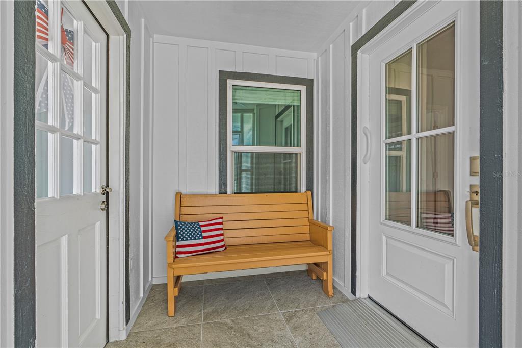 Entry, enclosed, left to the garage + Laundry and right to the home