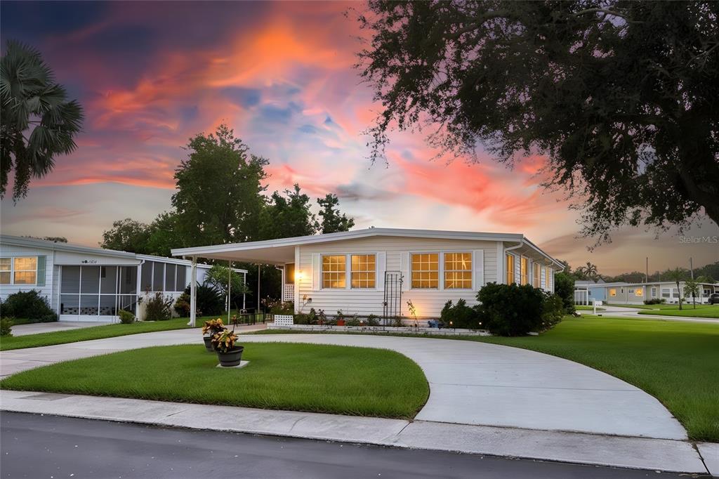 AND-OWNED CORNER LOT WITH CIRCULAR DRIVE – ADDED SPACE & PRIVACY