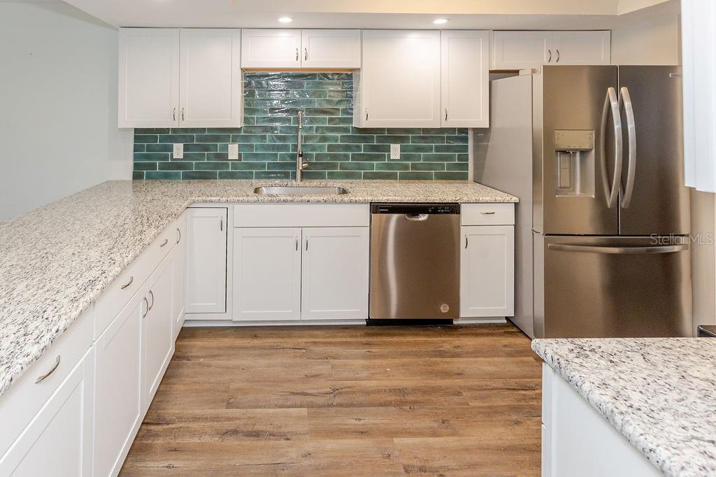 upgraded kitchen, granite and tile back splash