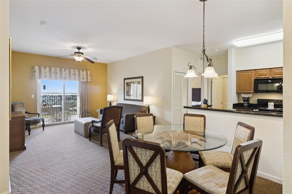 Living and Dining Area | An open layout connects the dining space, living room, kitchen, and balcony.