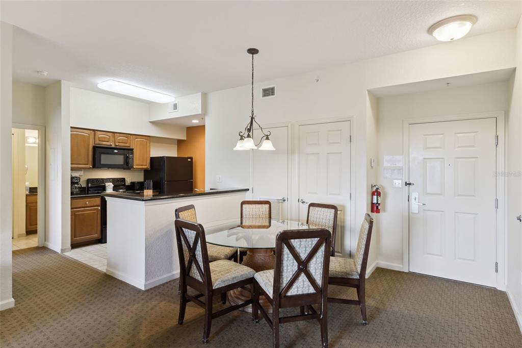 Dining Area | A dedicated dining space sits beside the breakfast bar and kitchen, creating a convenient gathering area.