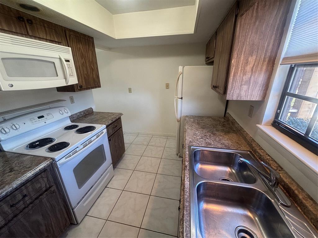 Galley style kitchen with high ceilings