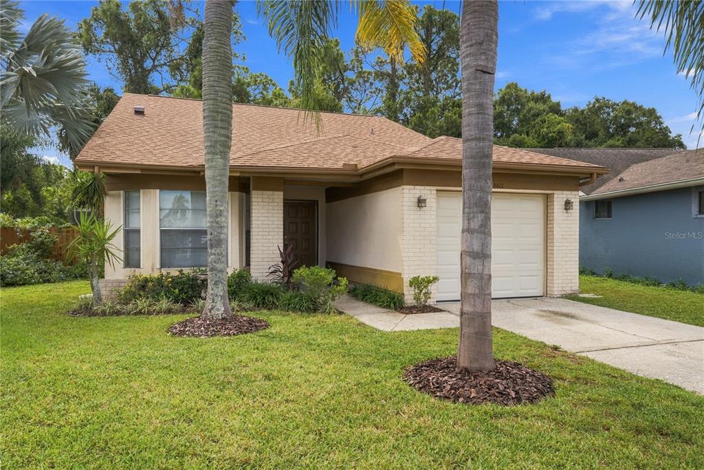 *NEW ROOF and Charming curb appeal with mature palms, lush landscaping, and a welcoming front entry.