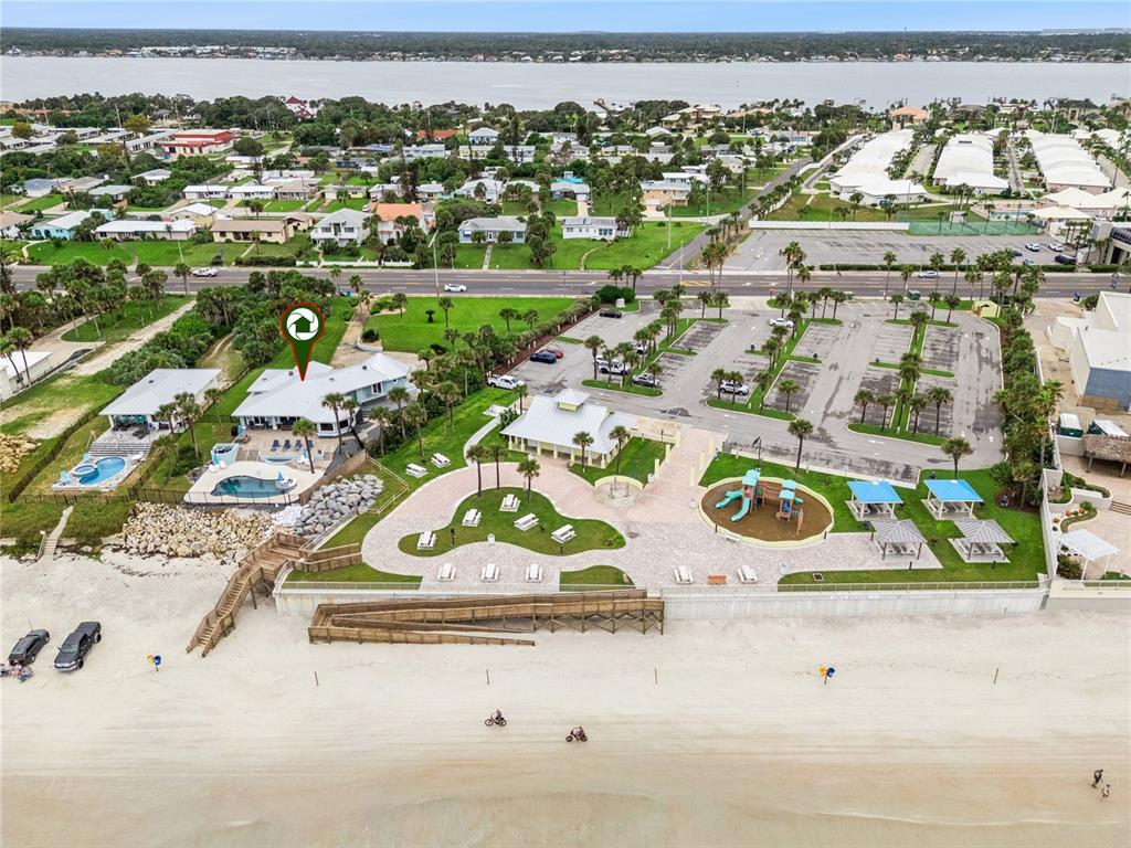 Set on over three-quarters of an acre with approximately 85 feet of ocean frontage, this property offers a generous setback from the road, ample driveway parking, and an attached garage. Neighboring Frank Rendon Park features a playground, covered picnic areas, restrooms, public beach access, and parking