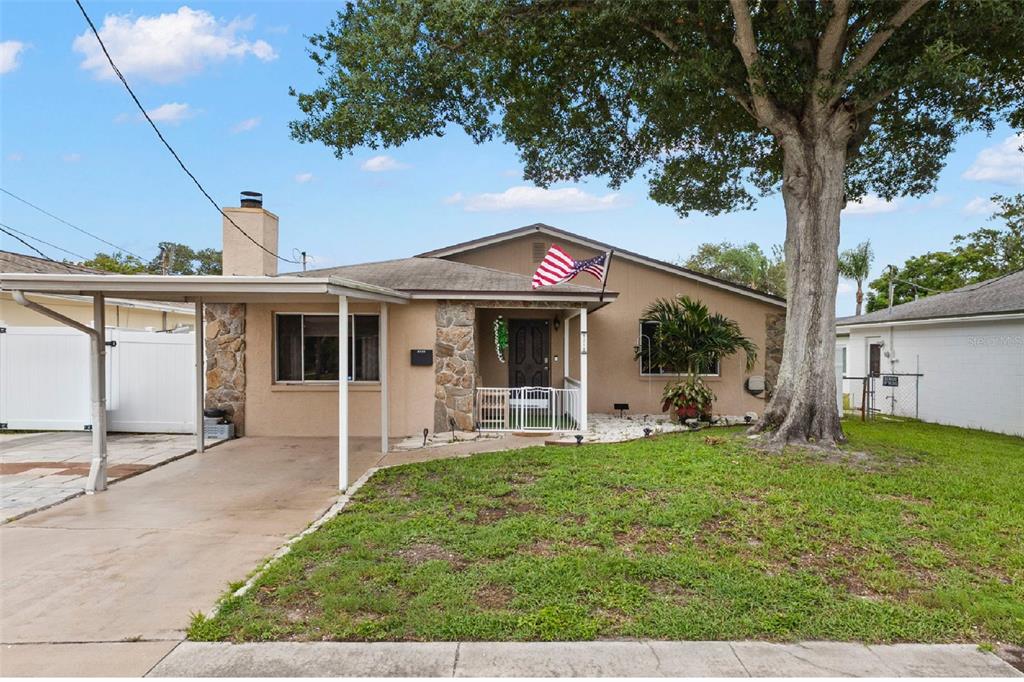 Welcome to this charming two-bedroom, one-bath Bayou Heights home featuring natural stone accents, a covered front porch, one-car carport, private pool, and a magnificent mature shade tree—all in Flood Zone X with no HOA or CDD.