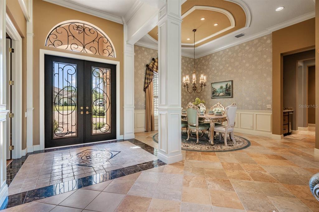 Dramatic entry with tile accent inlay in foyer & architectual details