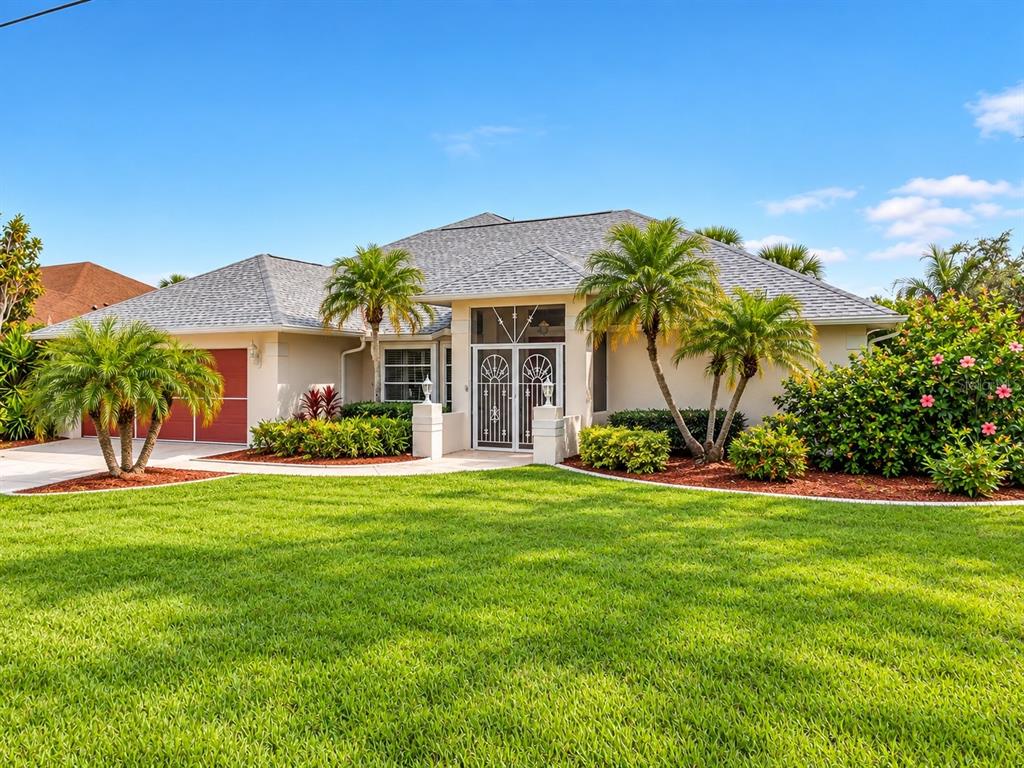Front exterior with mature landscaping and spacious lawn.