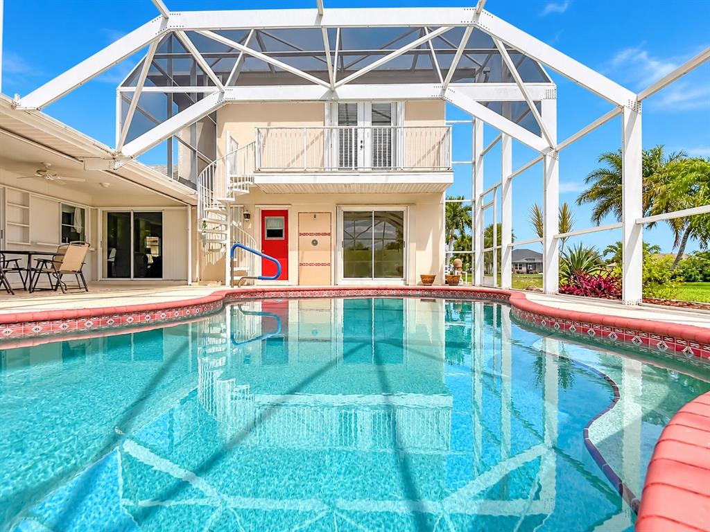 2. Screened pool with views of the rear exterior and upper balcony.