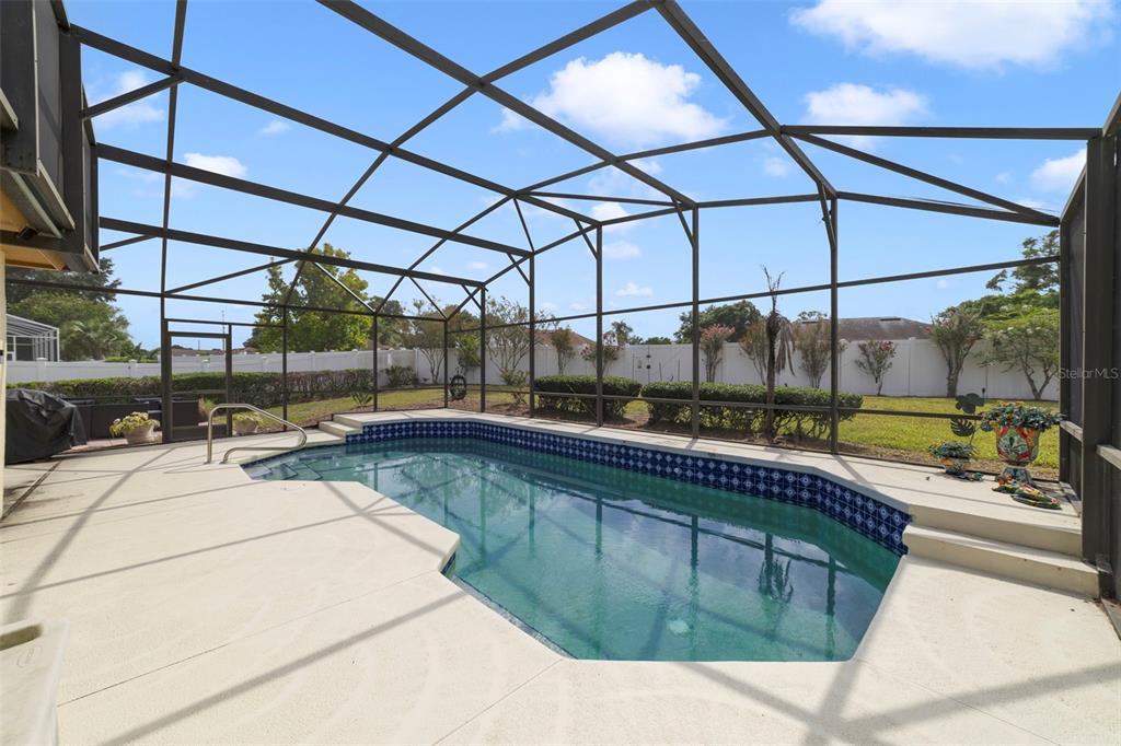 Enjoy the private screened pool overlook a fully fenced yard, and .27 acres.