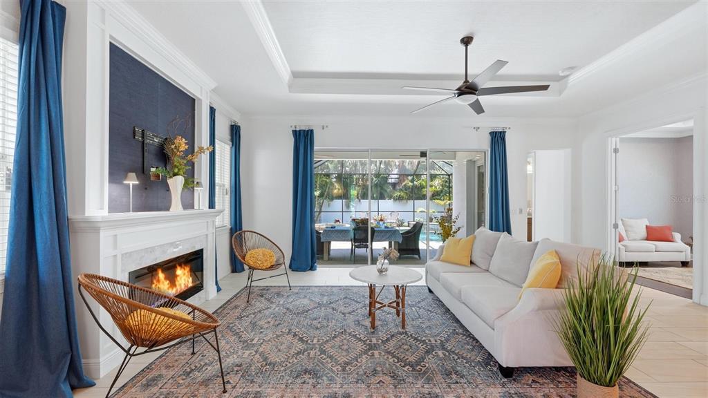 Living room sliders open to covered lanai, electric fireplace