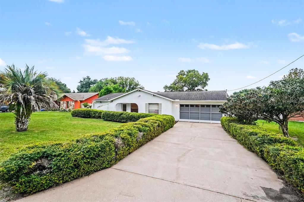 Wide Driveway Leads to Attached Two-Car Garage and Entry