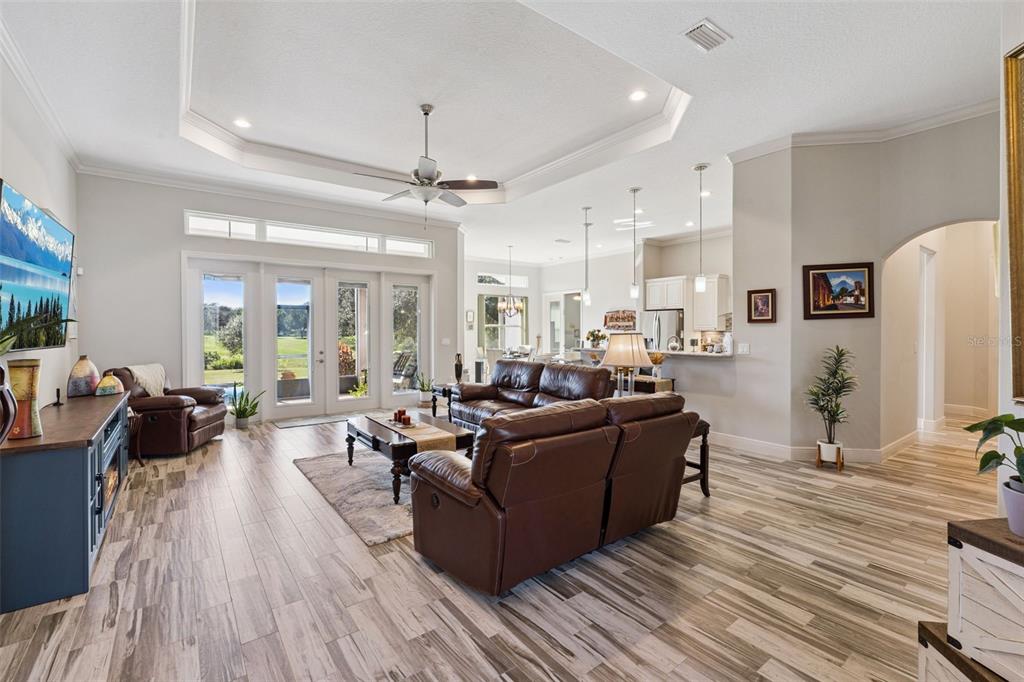 Welcome guests through the front double door into the open floor plan with family room with a beautiful water view